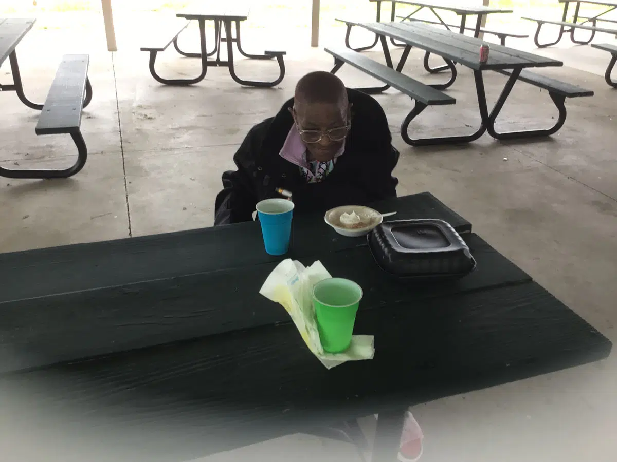 A person eating food in Owensboro Kentucky from Food for the Soul